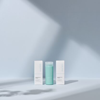2 boxes of cleanser and one bottle of cleanser are on the floor against blue wall background