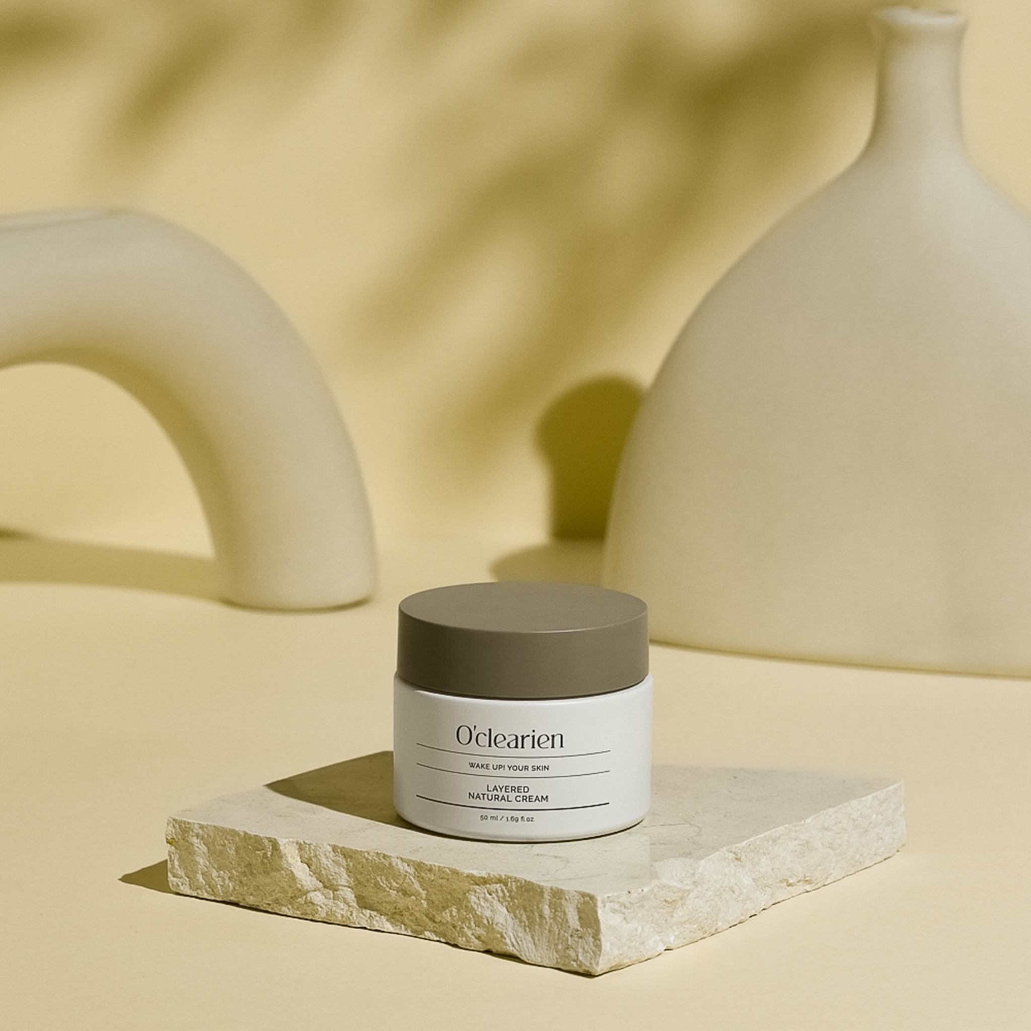 natural cream is on a rock against two yellow potteries background.