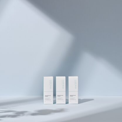 three boxes of cleanser and one bottle of cleanser are on the floor against blue wall background